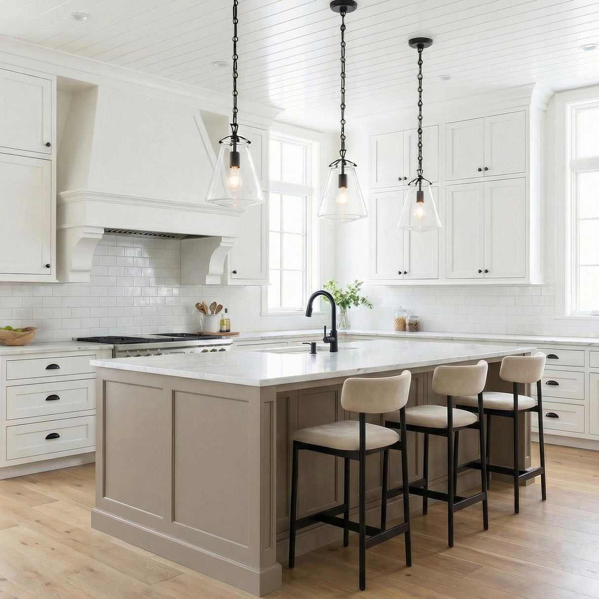Addison Matte Black geometric pendant in a Modern Farmhouse Kitchen with a white marble island and tan bar stools.