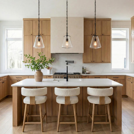 Cora Matte Black geometric pendant in a Modern Farmhouse Kitchen with a white marble island and bouclé bar stools.
