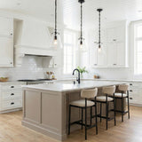 Addison Matte Black geometric pendant in a Modern Farmhouse Kitchen with a white marble island and tan bar stools.