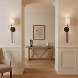 Briar Wall Sconce 24, Old Bronze - Two elegant wall sconces with white shades and old bronze fixtures illuminate a hallway with a wooden console table and artwork.