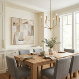 Hollis 6 Light Chandelier 24", Aged Brass geometric chandelier in a Transitional Dining Room with a light wood dining table and grey upholstered chairs.