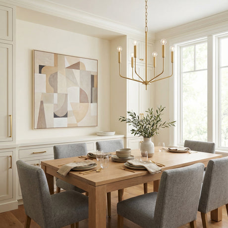 Hollis 6 Light Chandelier 24", Aged Brass geometric chandelier in a Transitional Dining Room with a light wood dining table and grey upholstered chairs.