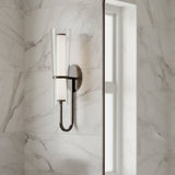 Wall-mounted Clair 20" fixture on a marble wall in a bathroom.