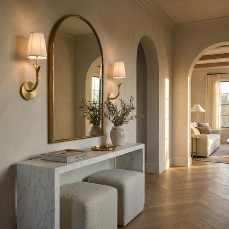 Magnolia Single, Aged Brass leaf design Wall Sconce in a Transitional Entryway with white marble console and arched mirror.