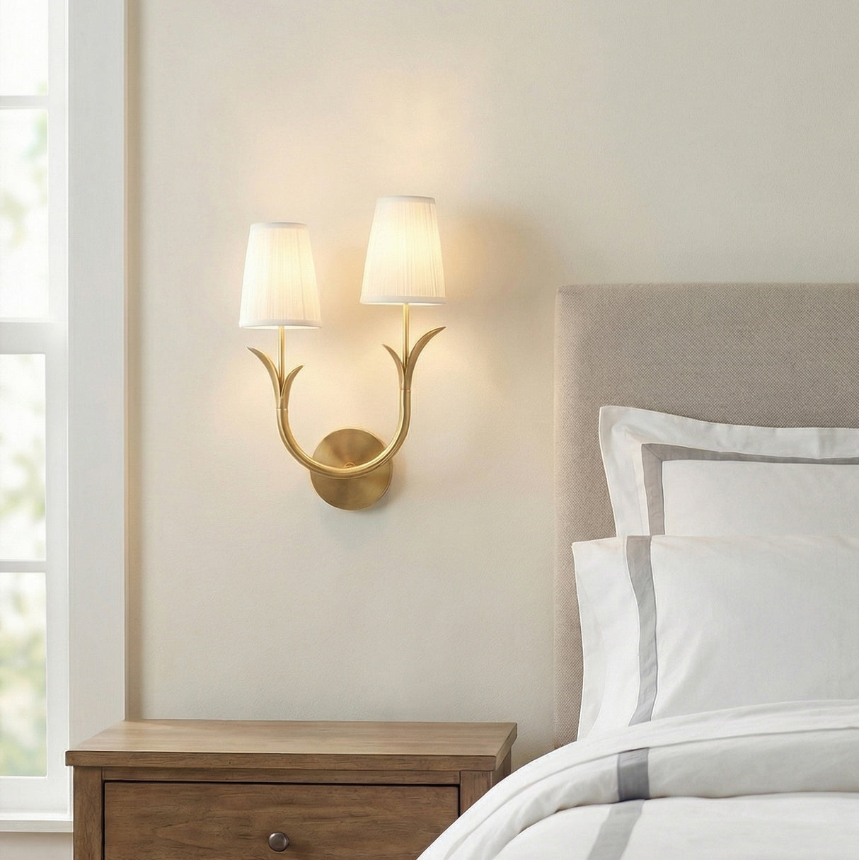 Double Wall Sconce, Aged Brass leaf design wall sconce in a Transitional Bedroom with upholstered headboard and wooden nightstand.