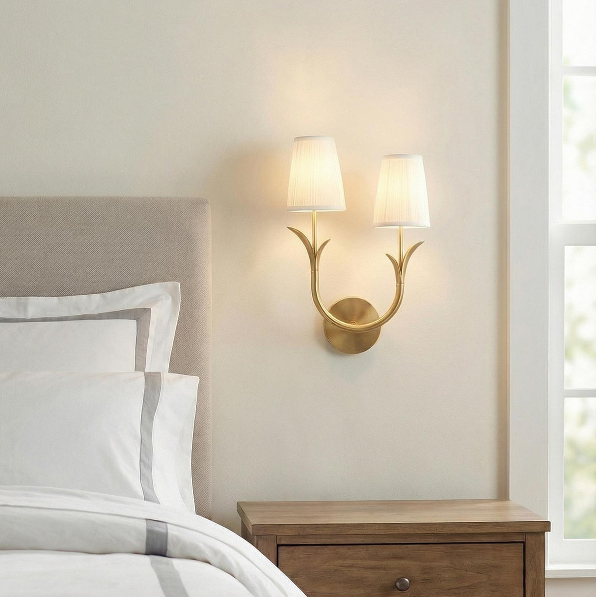 Double Wall Sconce, Aged Brass leaf design wall sconce in a Transitional Bedroom with upholstered headboard and wooden nightstand.