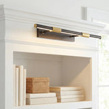 Ethan Large LED Picture Light, Distressed Bronze with Brass Accents linear wall sconce in a Transitional Living Room with white built-in bookshelf.