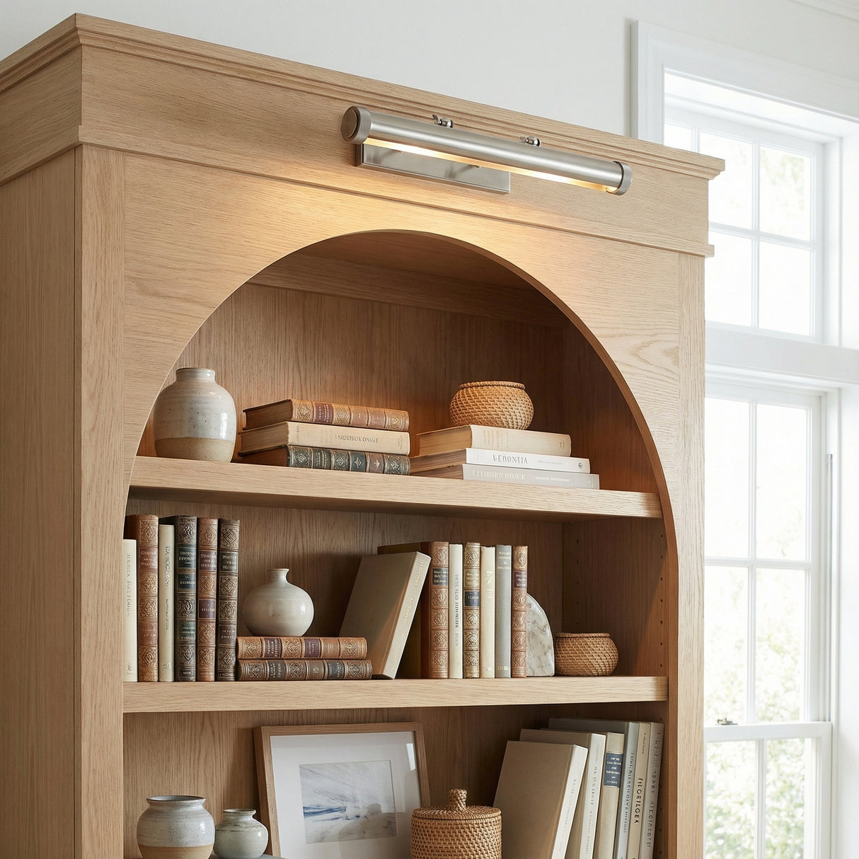 Graham Large Picture Light, Vintage Nickel linear Picture Light in a Transitional Living Room with a natural oak bookcase.