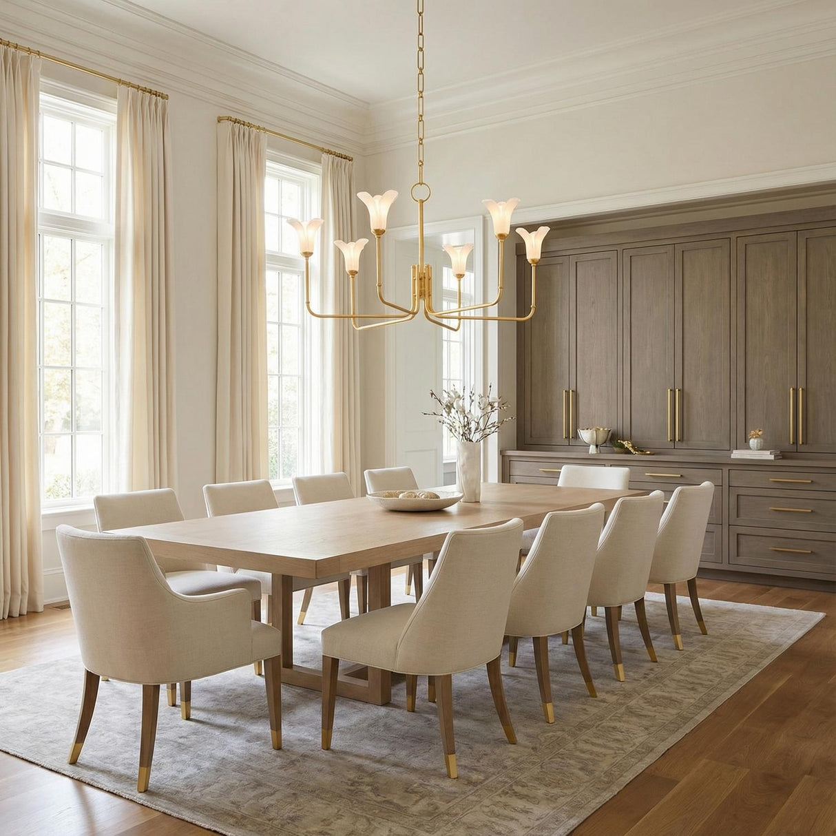 Dahlia 6 Light Chandelier 40", Gold Leaf scalloped chandelier in a Transitional Dining Room with a light wood dining table and upholstered chairs.