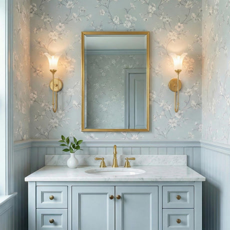 Dahlia Gold scalloped glass Wall Sconce in a Traditional Bathroom with floral wallpaper and a marble vanity.
