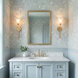 Dahlia Gold scalloped glass Wall Sconce in a Traditional Bathroom with floral wallpaper and a marble vanity.