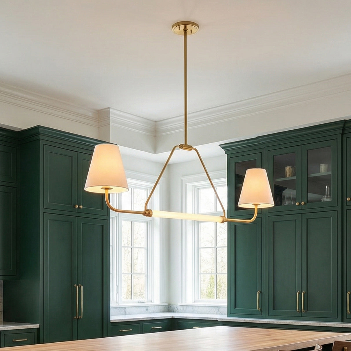 Milton 2 Shade Linear Pendant 48", Aged Brass and Soft White linear Pendant in a Transitional Kitchen with green cabinets & wooden island.
