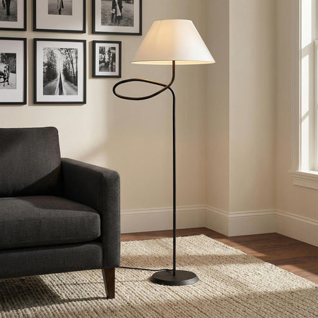Odin Floor Lamp, Forged Iron styled in a Modern Living Room with dark grey sofa and textured rug.