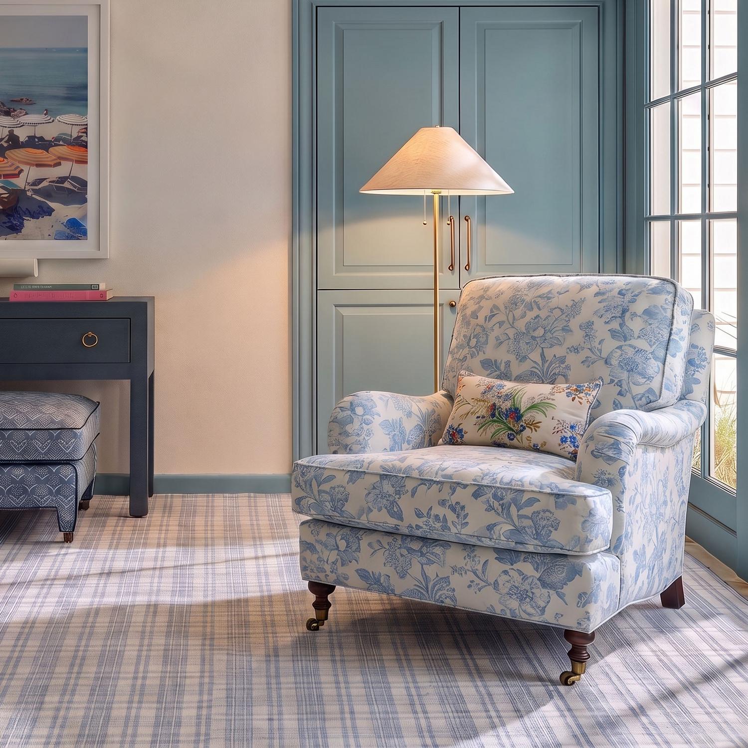 A traditional living room features the Tessa Floor Lamp, Textured Beige with Aged Brass, standing beside a blue floral armchair on a plaid rug.