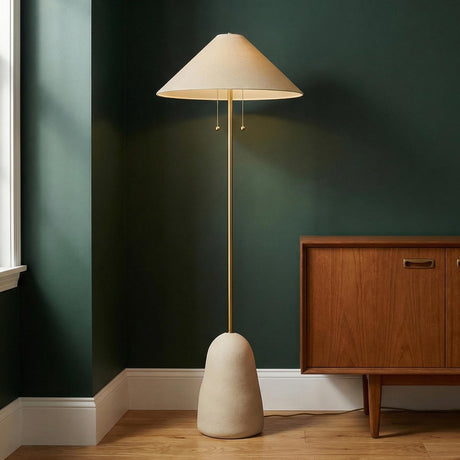 Tessa Floor Lamp, Textured Beige with Aged Brass linear floor lamp in a Mid-Century Living Room with a wood cabinet.