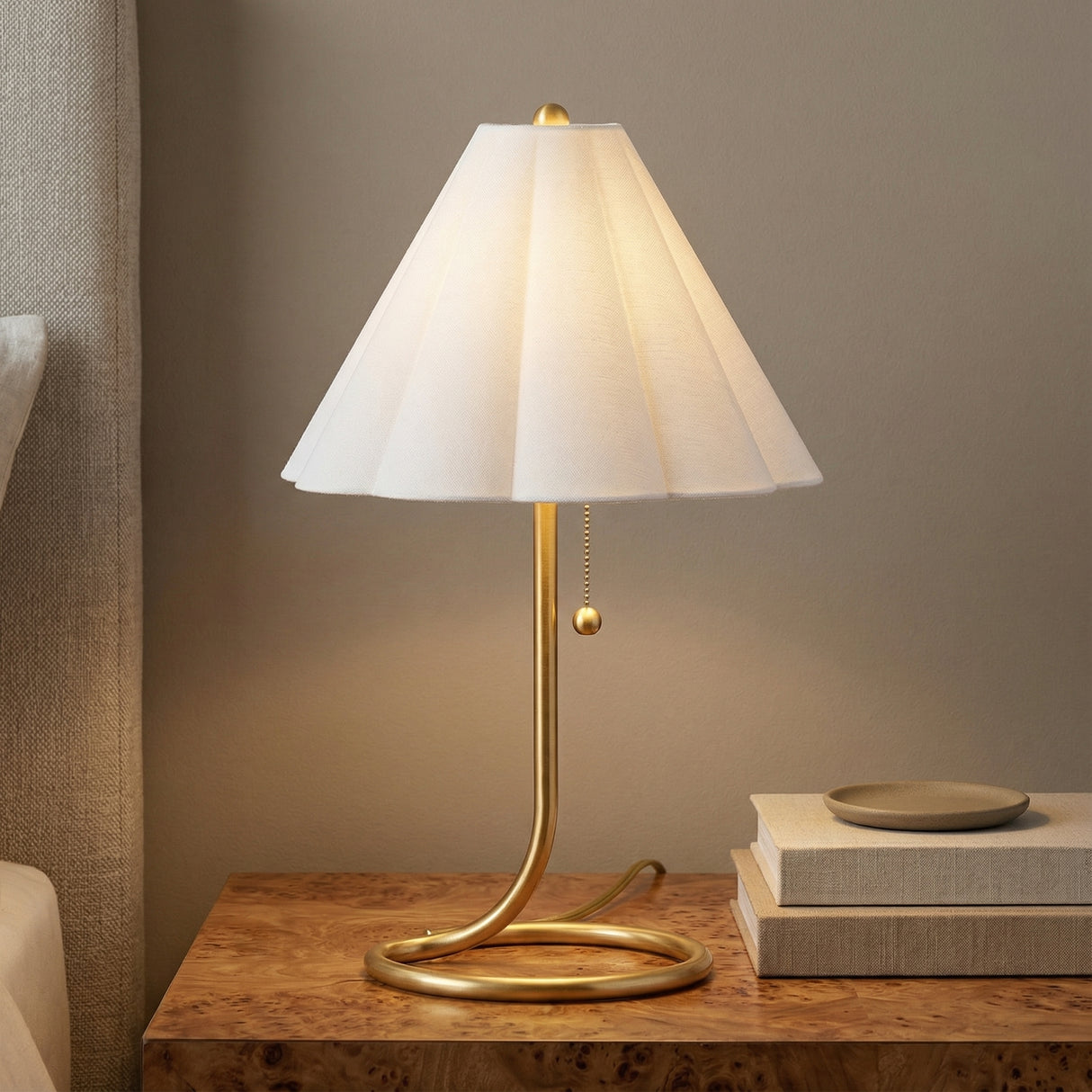 Aged Brass linear Table Lamp in a Transitional Bedroom with a burl wood nightstand.