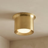 Jonah LED Flush Mount 7", Aged Brass geometric flush mount in a Modern Living Room with clean, neutral walls.