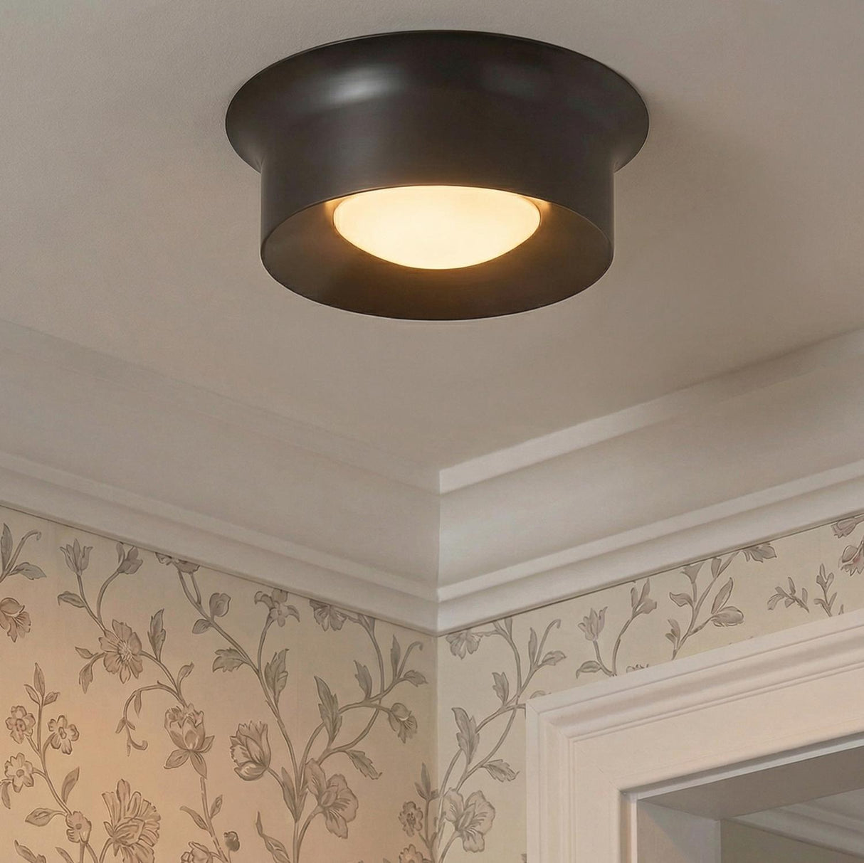Jonah LED Flush Mount 14", Bronze geometric flush mount in a Traditional Hallway with floral wallpaper and white crown molding.