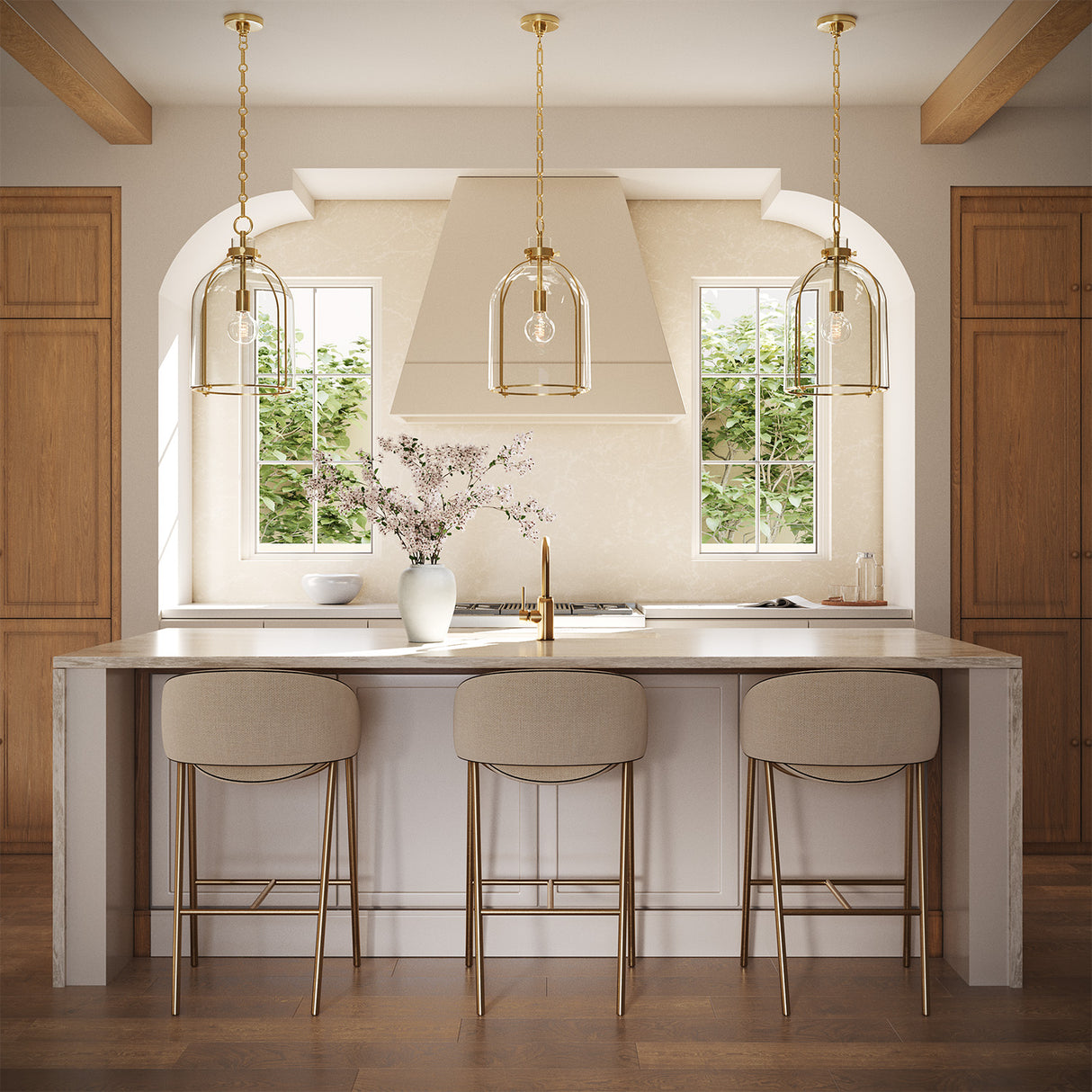 Three 16" wide Lana Pendants hung in a kitchen with oak cabinets, white counters, and neutral furnishings.