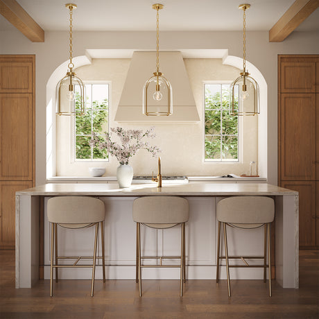 Three 16" wide Lana Pendants hung in a kitchen with oak cabinets, white counters, and neutral furnishings.