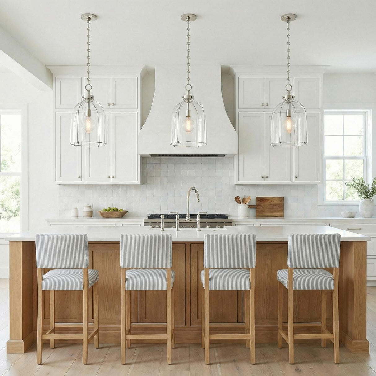 Lana Pendant 16", Polished Nickel and Clear Glass globe pendant in a Modern Farmhouse Kitchen with a white marble island and oak stools.