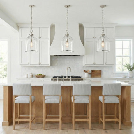 Lana Pendant 16", Polished Nickel and Clear Glass globe pendant in a Modern Farmhouse Kitchen with a white marble island and oak stools.