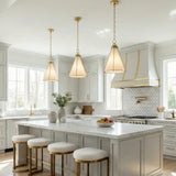 Brass and Cream geometric pendant in a Transitional Kitchen with a white marble island.