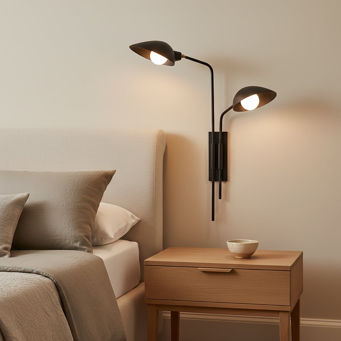 Modern Royce Plug-in Wall Sconce above a wooden nightstand in a bedroom setting.