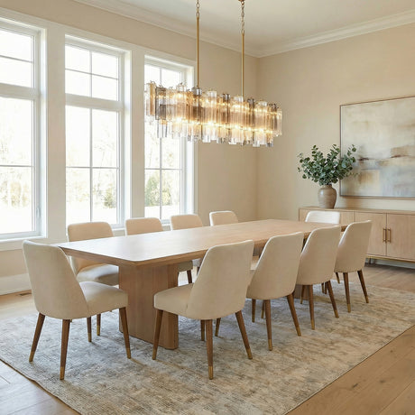 Grace Linear Chandelier 52", Brass with Gilded Fog Glass Brass linear Chandelier in a Transitional Dining Room with a light oak table.