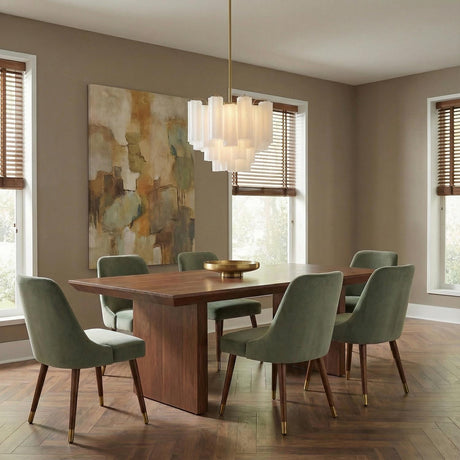 Linear brass chandelier with white glass tubes in a Mid-Century Dining Room with a walnut table and green velvet chairs.