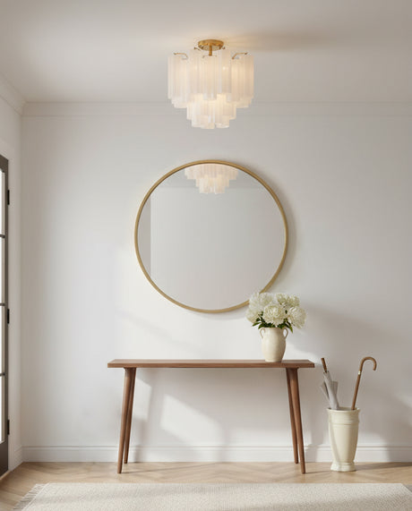 Grace Semi-Flush 18, Brass with White Glass - A brass semi-flush mount light with white glass shades hangs above a wooden console table with a round gold mirror and a vase of white flowers.