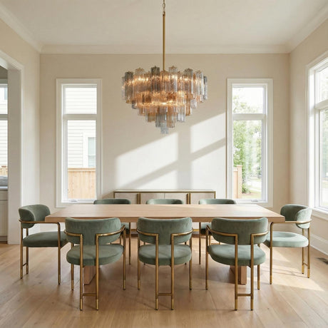 Grace 16 Light Chandelier 32", Brass with Gilded Fog Glass linear chandelier in a Transitional Dining Room with sage green velvet chairs.