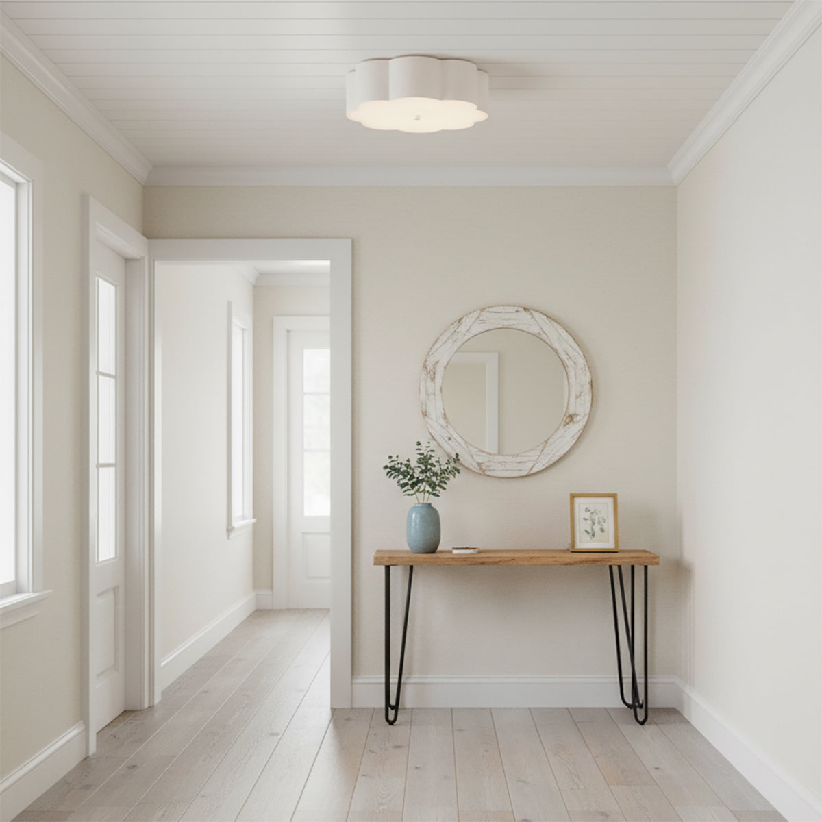 Shana Flush Mount 14, Antique White - A white flower-shaped flush mount light fixture illuminates a bright and airy hallway with light wood floors and a console table.