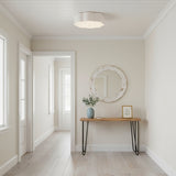 Shana Flush Mount 14, Antique White - A white flower-shaped flush mount light fixture illuminates a bright and airy hallway with light wood floors and a console table.