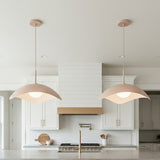 A contemporary kitchen with two Presley Pendant 22", Blush pendants featuring a blush finish and frosted glass globes over the island with white shaker cabinetry.