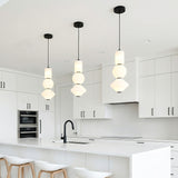 Shai LED Pendant 8", Matte Black and Opal Glass geometric Pendant in a Modern Kitchen with white kitchen island and wood bar stools.