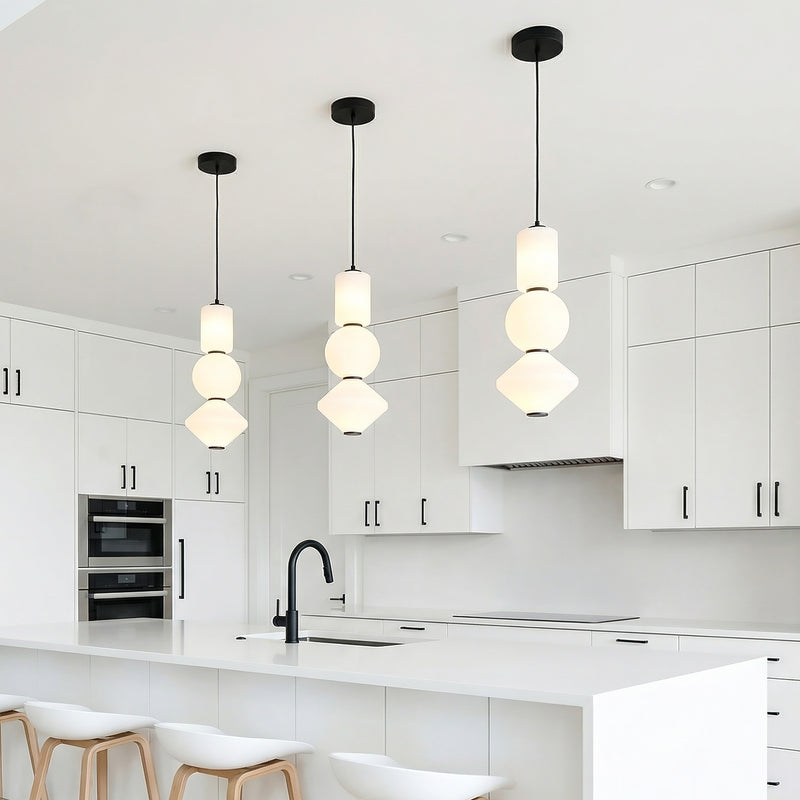 Shai LED Pendant 8", Matte Black and Opal Glass geometric Pendant in a Modern Kitchen with white kitchen island and wood bar stools.