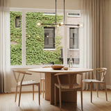 Gurt 4 Light Linear Pendant 48", Matte Black linear Pendant in a Modern Dining Room with round oak table and woven chairs.