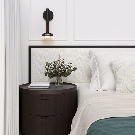Bedroom with a nightstand, bed, and the Sheila 1 Light LED Wall Sconce 14", finished in Matte Black and Walnut wood.