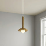 Sheila LED Pendant 9", Brushed Brass geometric pendant in a Modern Living Room with plain grey walls.