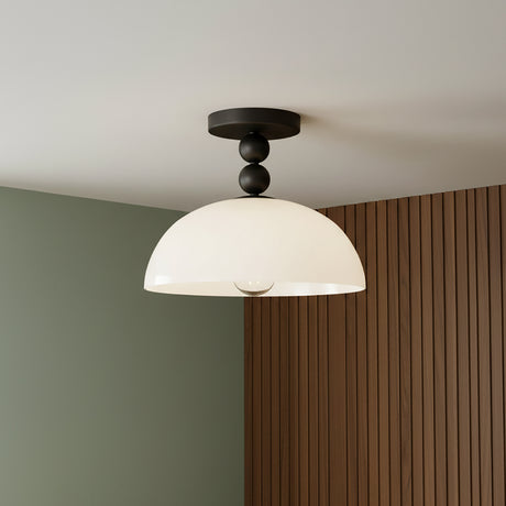 modern and playful ceiling light with matte black ball accents and white glass shade.