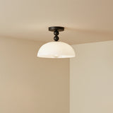 Archie Flush Mount 12, Matte Black and Opal Glass - Flush mount light fixture against a neutral colored wall.