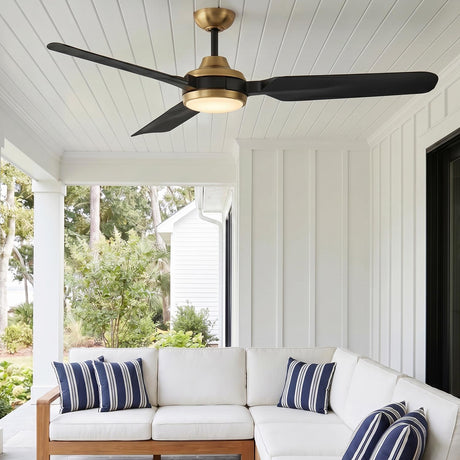 A coastal porch with a brushed brass and matte black Hobbs LED Ceiling Fan 60" mounted on the porch ceiling above a white outdoor sectional.