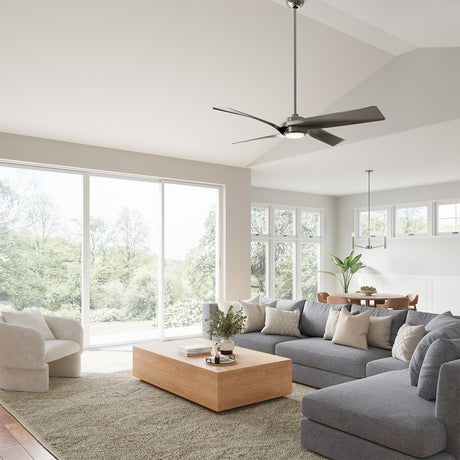 Modern living room with gray sofa, wooden coffee table, and large windows, featuring the Largo LED Ceiling Fan 56", in Brushed Nickel.