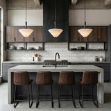 Sabina Matte Black pleated pendant in an Industrial Kitchen with a concrete island and leather barstools.