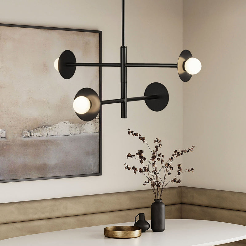 Modern black SOL LED chandelier in a room with a vase and decorative items on a table.