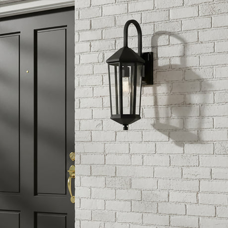 Black Asbury Outdoor Wall Light, Small 23" tall on a white brick wall next to a black door.
