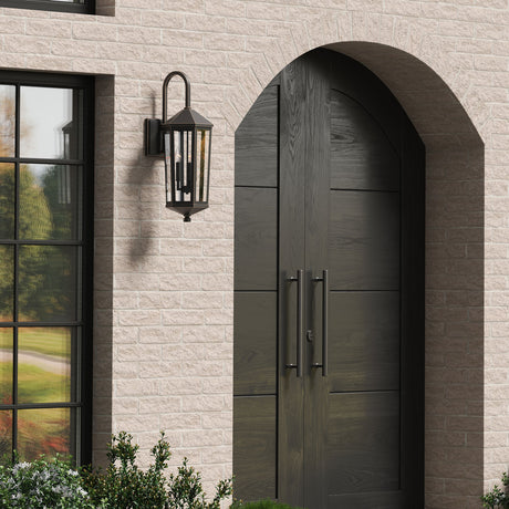 Brick arched entry with the Asbury Outdoor Wall Light, Medium 29" tall in Oiled Bronze finish to the left of the double doors.