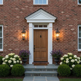 Asbury Outdoor Wall Light, Medium 29" Oiled Bronze - A brick house with a brown wooden door and two outdoor wall lights