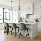 Nash Pendant 14”, Matte Black geometric Pendant in a Modern Kitchen with a white marble island and green velvet stools.
